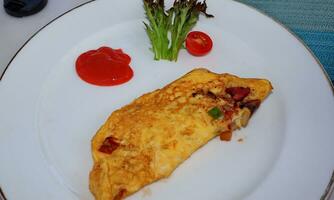 Omelet served with vegetables and spicy sauce photo