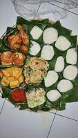 Indonesian various food for thanksgiving. Indonesian call it nasi berkat photo