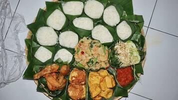 Indonesian various food for thanksgiving. Indonesian call it nasi berkat photo