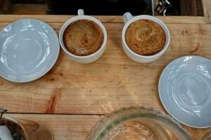 coffee is being poured, showing coffee drops and puffs of steam photo