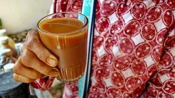 The herbalist is serving the customer, selling Jamu or herb from indonesia photo