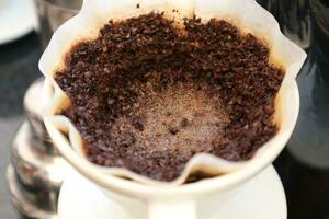 coffee is being poured, showing coffee drops and puffs of steam photo