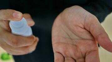 Hand of lady that applying alcohol spray or anti-bacteria spray to prevent the spread of germ photo