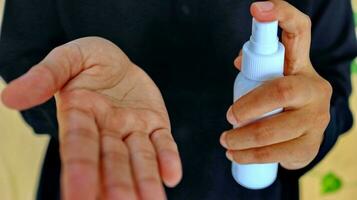 Hand of lady that applying alcohol spray or anti-bacteria spray to prevent the spread of germ photo