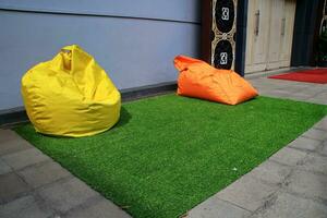 Bean Bag is a chair filled with styrofoam beads and without a frame photo