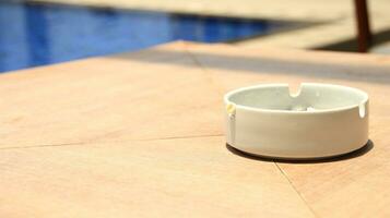 Closeup of empty ashtray with blurred background photo