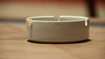 Closeup of empty ashtray with blurred background photo