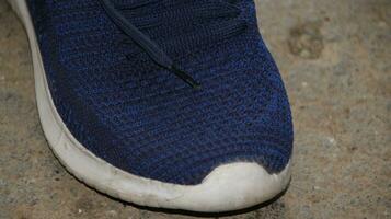 blue sport shoes, blue sneakers on dirty floor photo