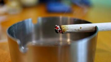 Cigarettes in ashtray at smoking are photo