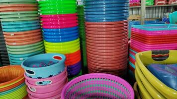 Cheap plastic household items for sale on the market close up photo