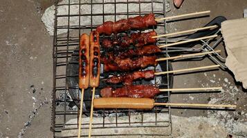 sausages and meat grilled over the fireplace with spicy soy sauce photo