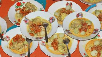 Lontong sayur or vegetable rice cake is an Indonesian traditional food photo