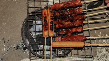 sausages and meat grilled over the fireplace with spicy soy sauce photo