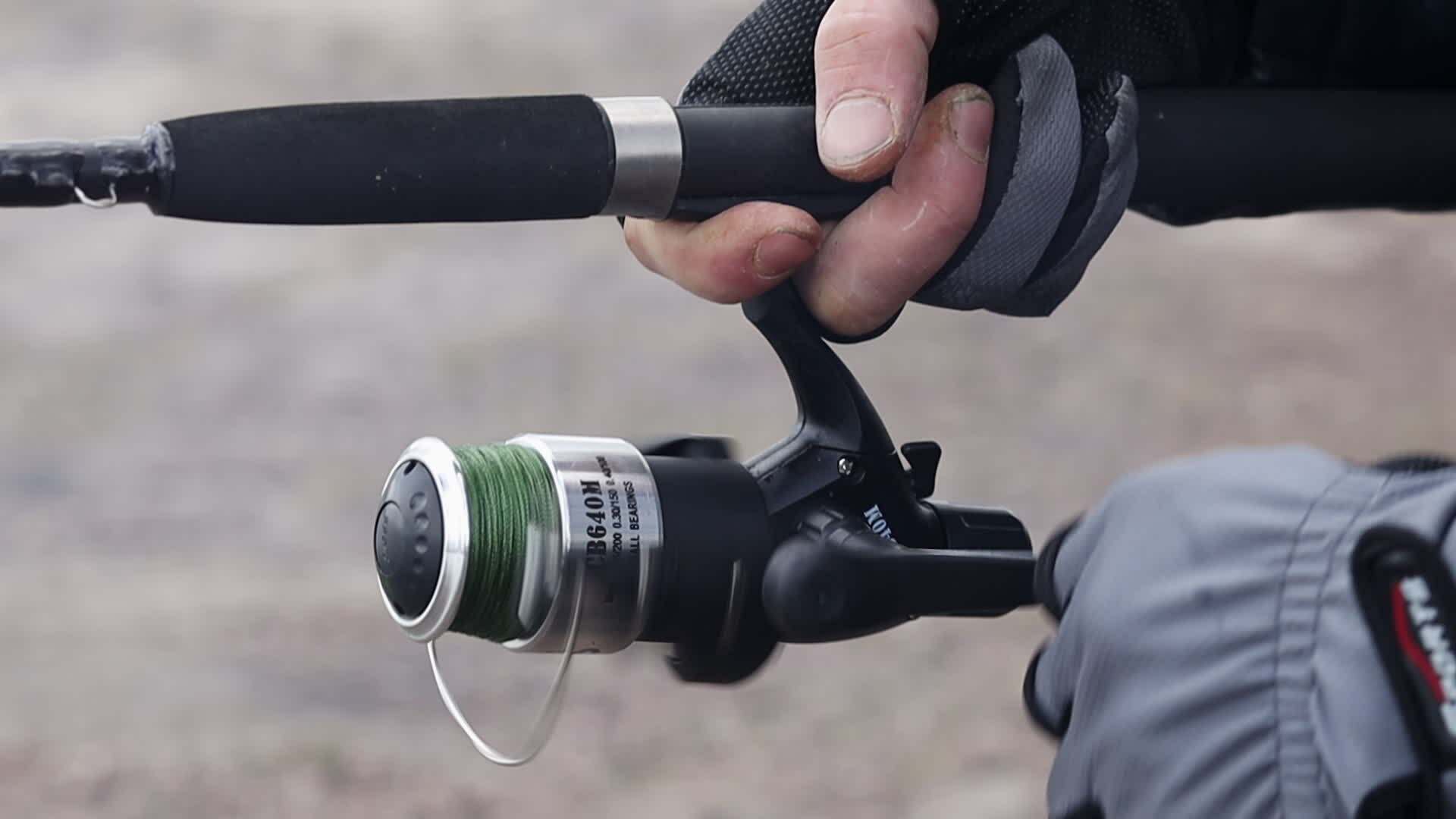 Close up of a fisherman's hands with a spinning reel. Spin fishing