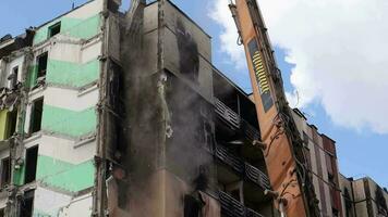 The destruction of a multi-storey building after being hit by an artillery shell. A burnt-out high-rise building in a war zone. War in residential areas, broken windows. Ukraine, Irpin - May 12, 2023. video