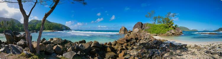 Panorama of port glaud beach, white sandy beach, granite stones and turquoise water, Mahe Seychelles photo