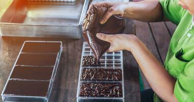 Close up of hand chef making homemade chocolate bars photo
