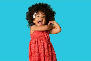 Portrait of cheerful happy african american little girl isolated over colored background photo