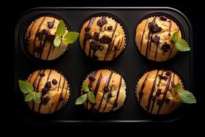 muffins with chocolate, top view, dark background. photo