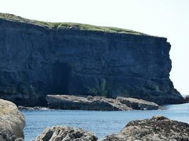 Cliffs and Atlantic ocean, clouds, rocks and laguna, beauty in nature. Vacation trip relaxation background photo