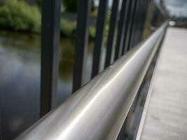 Bridge handrail with blurred abstract background, ancient bridge over the river background photo