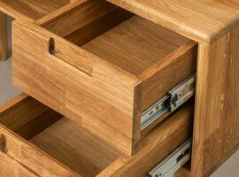 Opened drawers close view photo, wooden eco furniture elements background. Solid wood furniture details photo