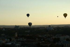 Hot air balloons flying over a city photo