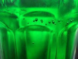 Green glass abstract background, close view photo