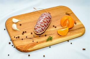 Tasty sausages and vegetables isolated over solid background photo