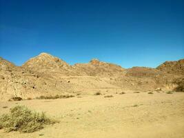 Desert land with mountains and sea photo