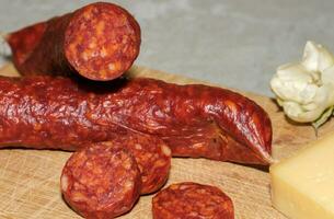 Tasty sausages isolated over solid background photo