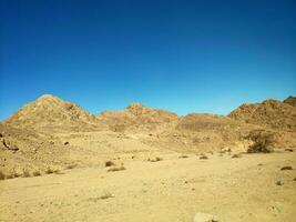 Desert land with mountains and sea photo