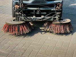 Broom of Road Sweeper Car Machine Close-up. Concept clean streets from debris. photo