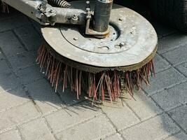 Broom of Road Sweeper Car Machine Close-up. Concept clean streets from debris. photo