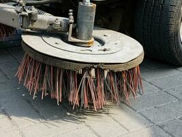 Broom of Road Sweeper Car Machine Close-up. Concept clean streets from debris. photo