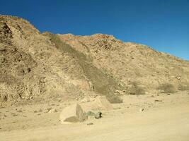 Desert land with mountains and sea photo