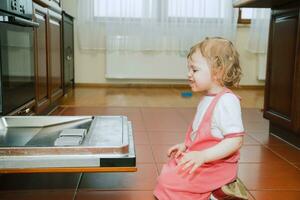 a little girl with the dishwasher photo