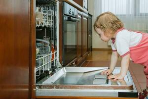 a little girl with the dishwasher photo