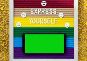 express yourself with colorful paper and colorful ribbon on wooden background photo