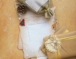 a paper with a christmas message and a pen on a brown background photo