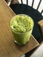 A Matcha green drink on a table top view photo