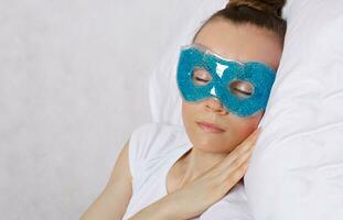 a woman wearing a blue eye mask photo