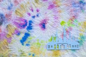 a tie dye fabric with a paper cutout of a castle photo