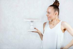 a woman holding a cake on a white background photo