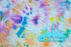 a tie dye fabric with a paper cutout of a mosque photo