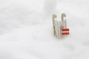 Winter sports equipment and Austrian flag in the snow. Free space for a text. photo