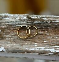 Wedding rings on wood photo