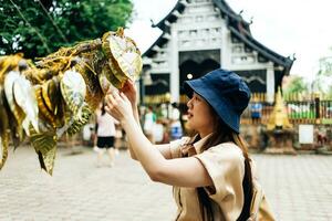 Asian traveller take a photo to Pagoda of wat lok moli temple in Chiang mai city, Thailand