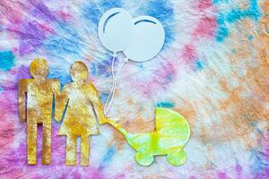 paper cutout of a family with balloons and a baby carriage photo