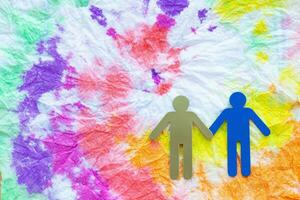 two people holding hands on a colorful background photo